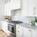 Modern Cabinet Pulls White Shaker On Kitchen Intended A Stainless Steel Oven Range Sits Against Herringbone 4